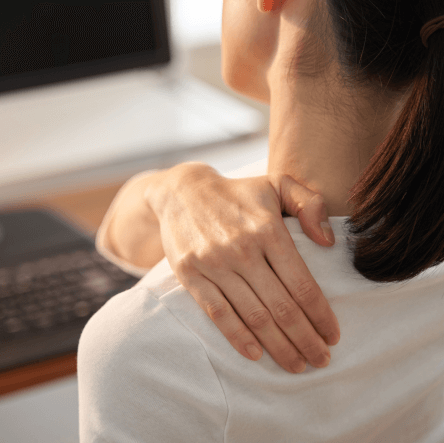 Woman in pain rubbing her shoulder