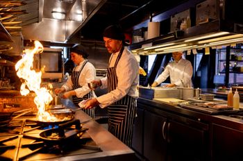 Chefs cooking in a commercial kitchen