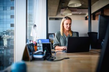 Businesswoman working on laptop in office