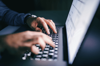 Close up of hands typing on laptop keyboard