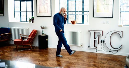 Man pacing room on cell phone