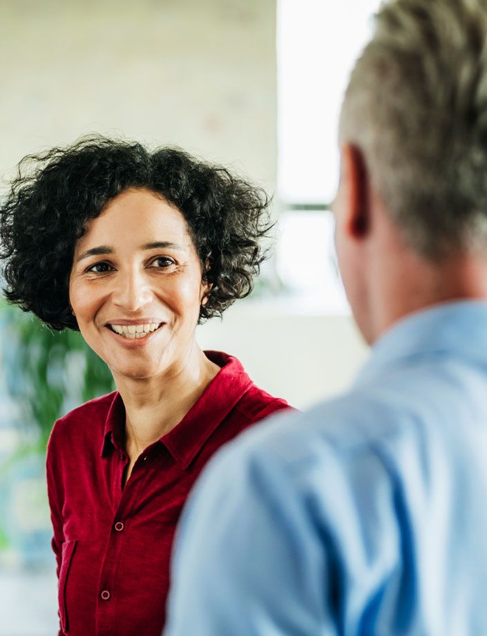 smiling woman speaking to man