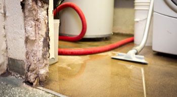 heavy duty vacuum cleaning up water on flooded floor