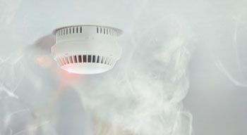 smoke rising up into ceiling with smoke detector