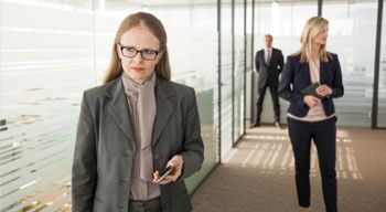 employees walking down hallway in office