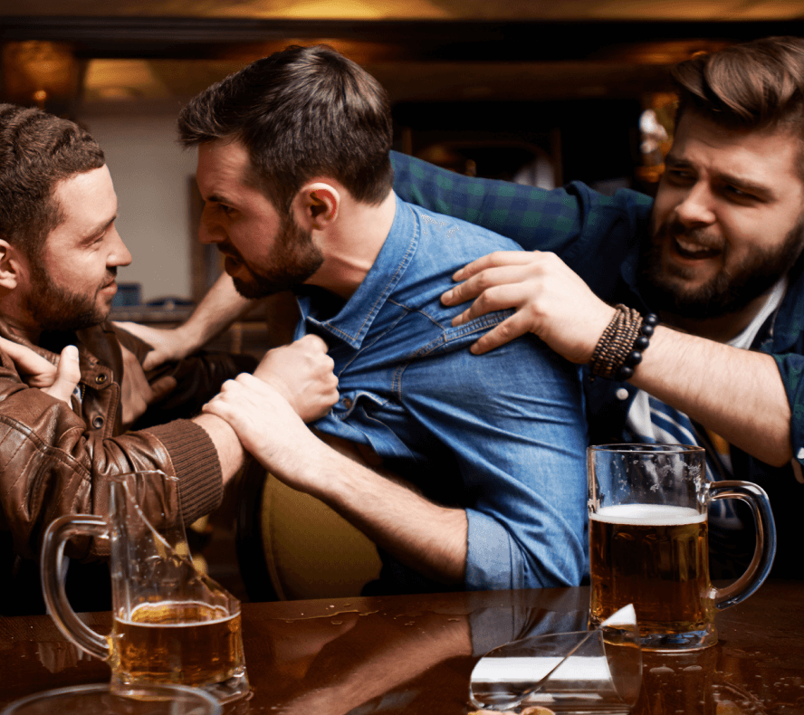 Two men in a bar fighting while another man tries to hold one back