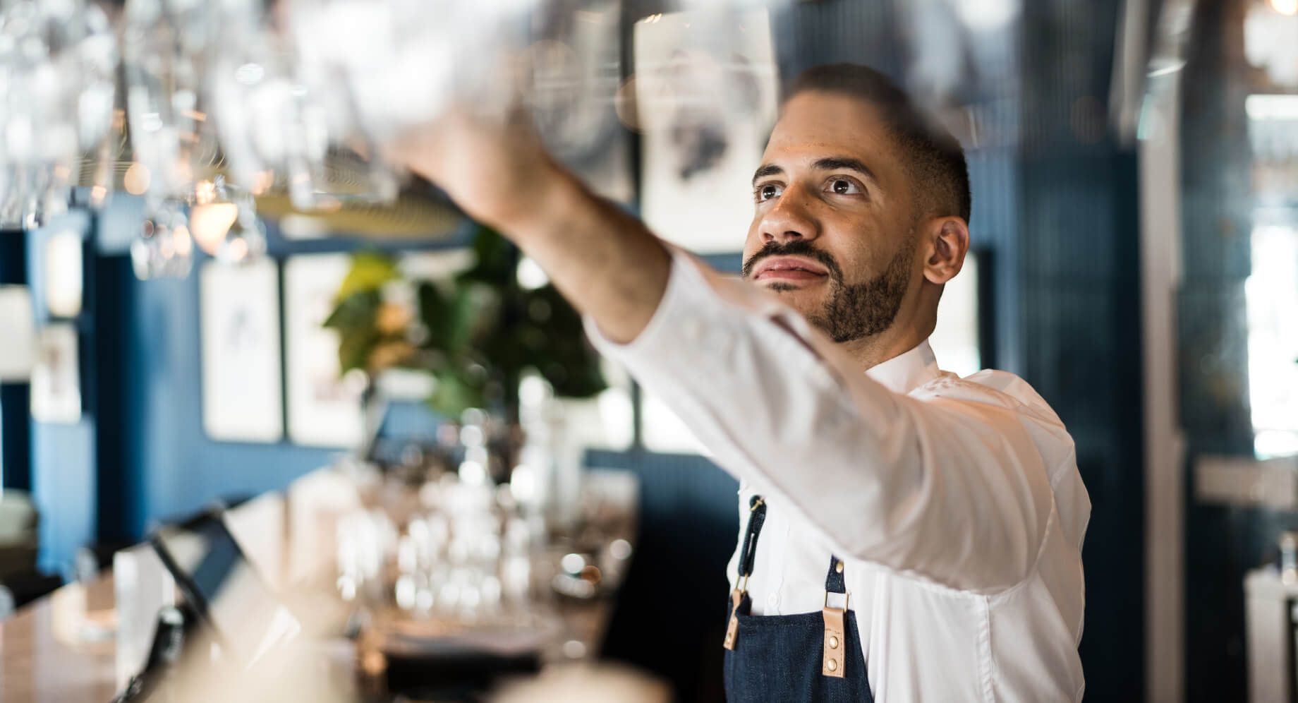 Bartender arranging glasses