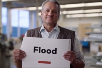 Man holding sign that says Flood